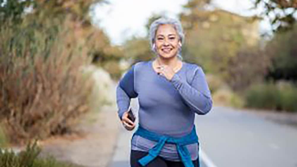 older overweight woman exercising outdoors