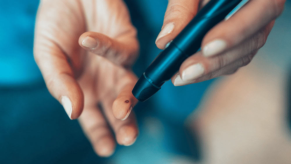 A finger testing blood glucose