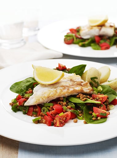 Fish with lentil spinach salad