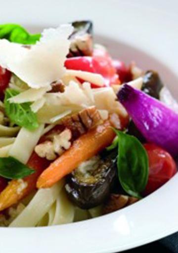 Vegetable pasta topped with parmesan and pecans