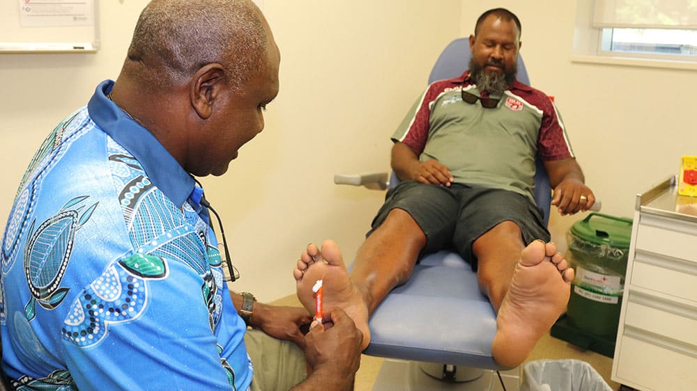 Person in the podiatrist's chair having their feet checked 