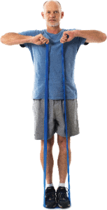 man standing with theraband underfoot and arms raised to shoulder height